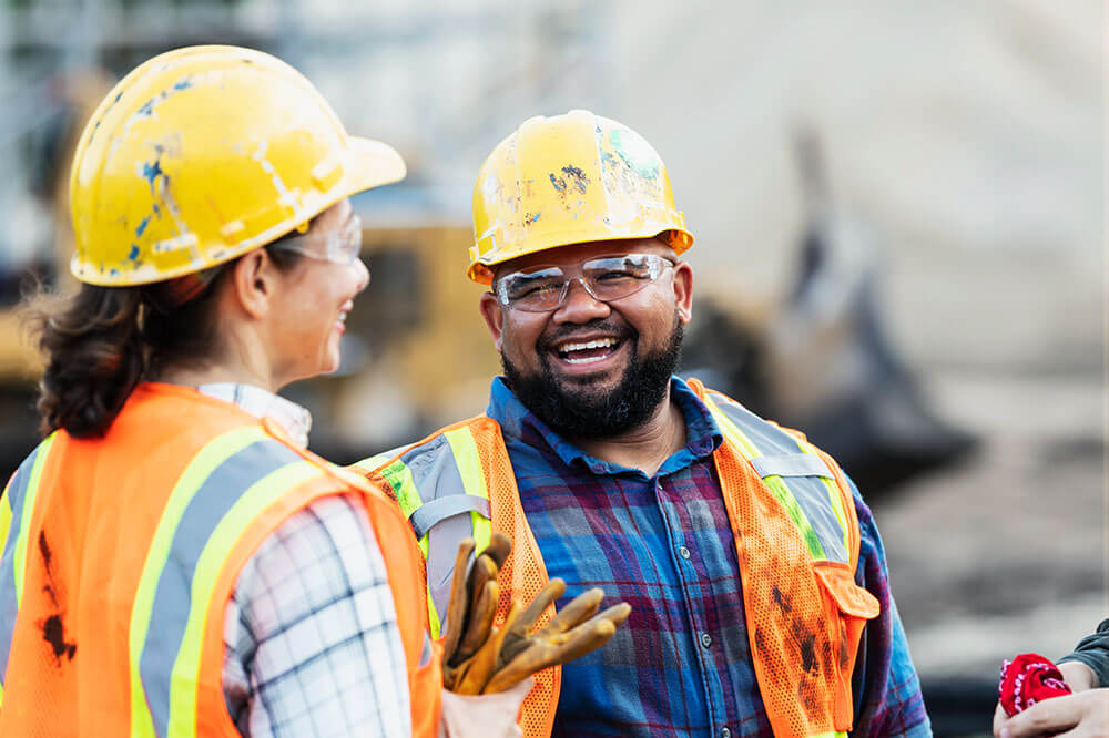 agg_indu_1 construction worker in hardhat laughing with coworker
