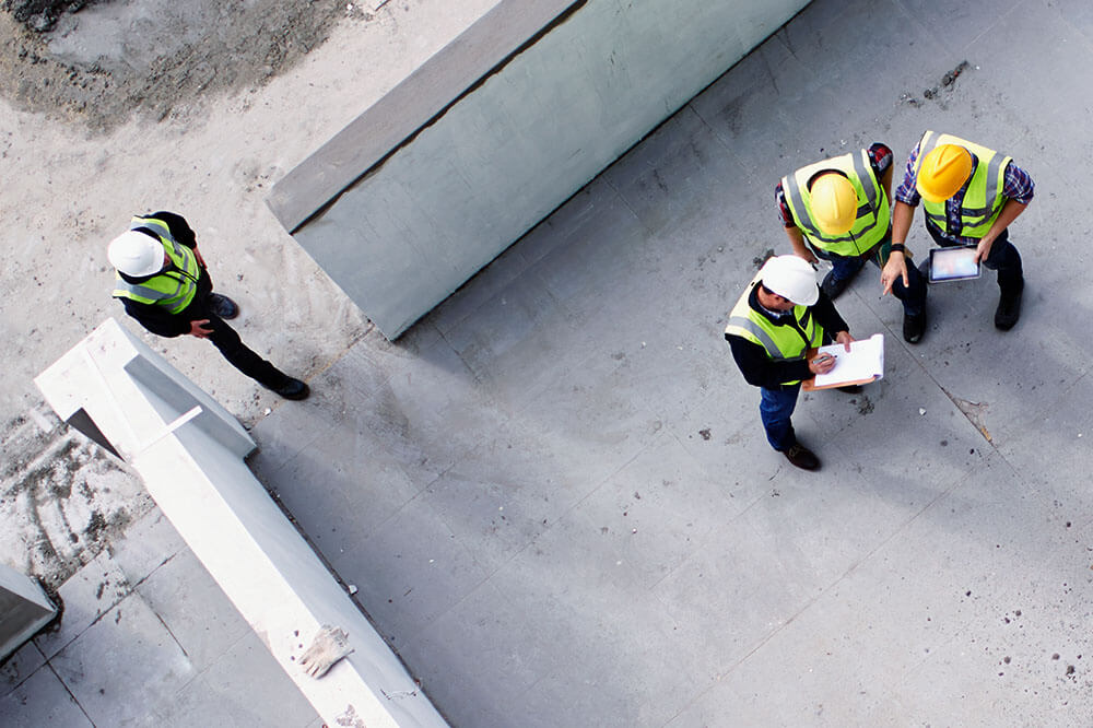 CP_Image_3 drone shot of construction workers looking over plans