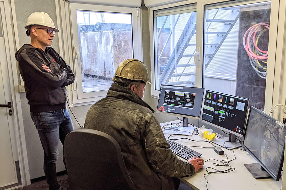 TOTAL PROCESS CONTROL female construction worker holding a tablet and smiling